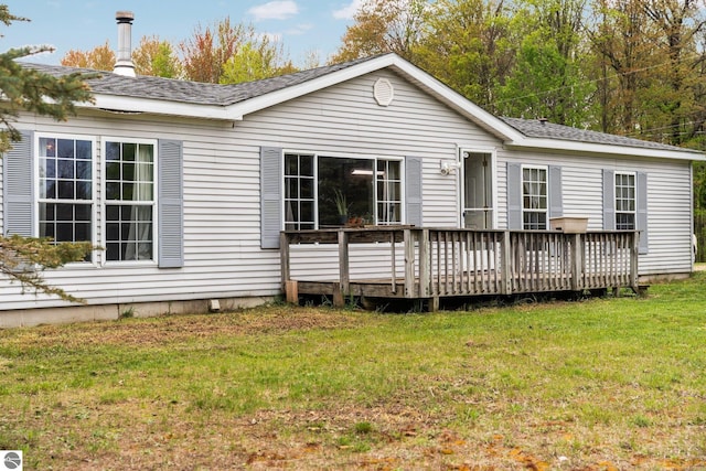 9170 Townline Rd, Kingsley, MI 49649 - back of property with a wooden deck, a yard, and roof with shingles