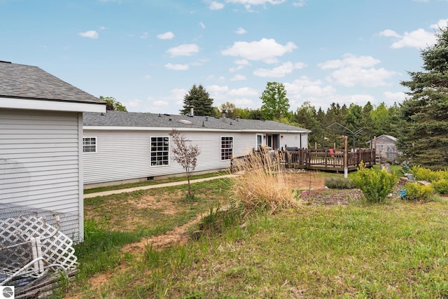 9170 Townline Rd, Kingsley, MI 49649 - rear view of property featuring a wooden deck and roof with shingles