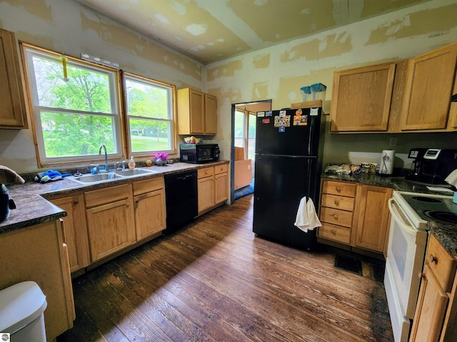 18846 Maple St, Copemish, MI 49625 - kitchen with black appliances, a sink, dark wood-type flooring, and dark countertops
