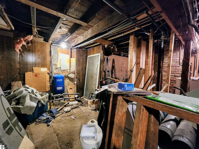 18846 Maple St, Copemish, MI 49625 - unfinished below grade area featuring a water pressure tank and wooden walls