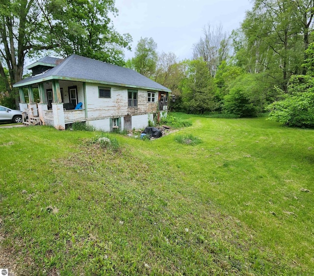 18846 Maple St, Copemish, MI 49625 - view of side of home with a porch and a lawn