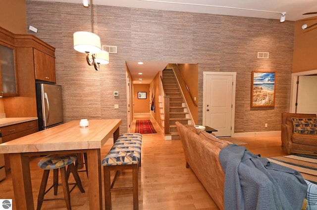 4365 W Burdickville Rd, Maple City, MI 49664 - living area featuring light wood finished floors, baseboards, and stairway