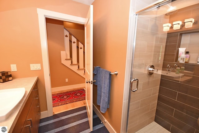 4365 W Burdickville Rd, Maple City, MI 49664 - full bathroom with vanity, a stall shower, and baseboards