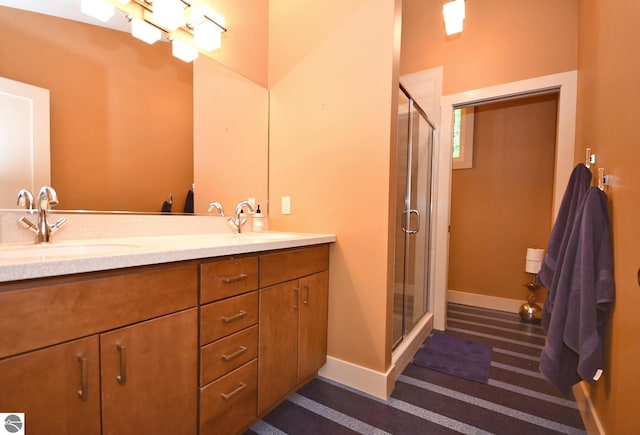 4365 W Burdickville Rd, Maple City, MI 49664 - full bath with double vanity, a stall shower, and baseboards