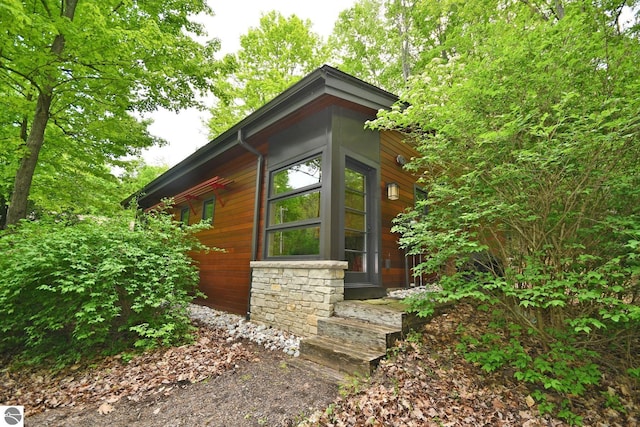4365 W Burdickville Rd, Maple City, MI 49664 - view of property exterior featuring stone siding