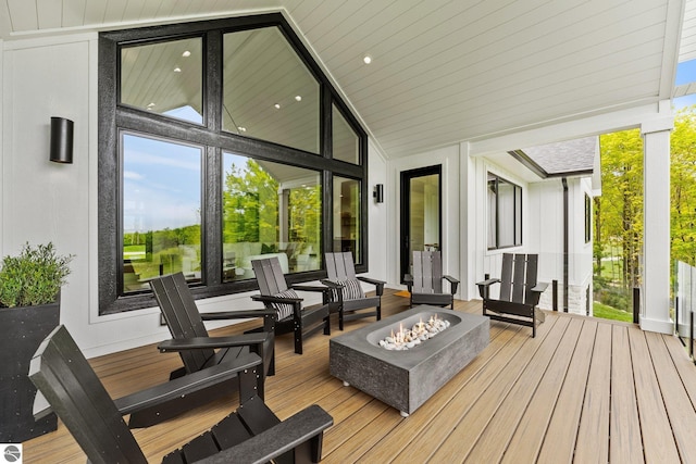 6848 S Carol Ann Dr, Traverse City, MI 49684 - wooden terrace featuring a fire pit