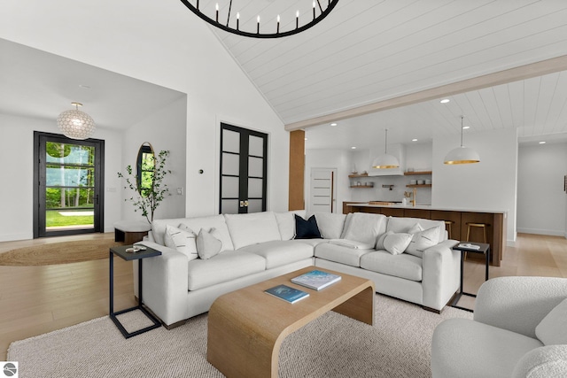 6848 S Carol Ann Dr, Traverse City, MI 49684 - living room with light wood finished floors, recessed lighting, baseboards, and a towering ceiling
