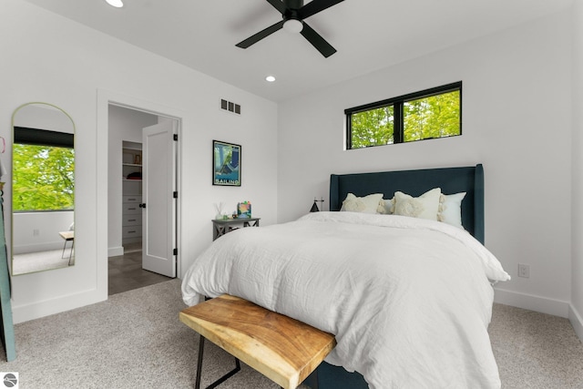 6848 S Carol Ann Dr, Traverse City, MI 49684 - bedroom with carpet floors, recessed lighting, a walk in closet, baseboards, and a ceiling fan