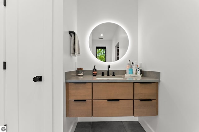 6848 S Carol Ann Dr, Traverse City, MI 49684 - bathroom featuring vanity, tile patterned flooring, and baseboards