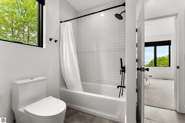 6848 S Carol Ann Dr, Traverse City, MI 49684 - bathroom with plenty of natural light, shower / bath combo with shower curtain, and toilet