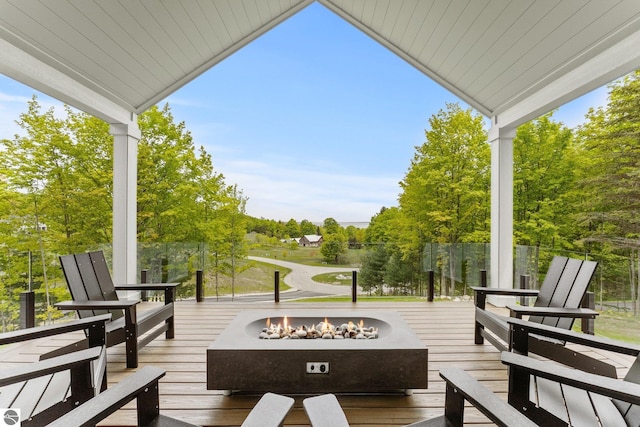 6848 S Carol Ann Dr, Traverse City, MI 49684 - deck with an outdoor fire pit and view of scattered trees