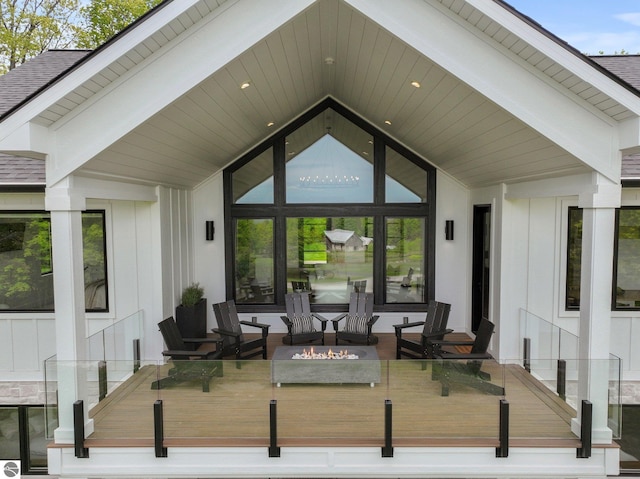 6848 S Carol Ann Dr, Traverse City, MI 49684 - wooden terrace featuring an outdoor fire pit