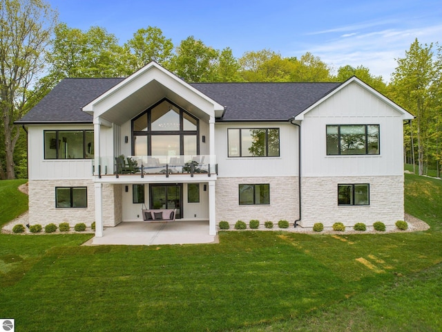 6848 S Carol Ann Dr, Traverse City, MI 49684 - rear view of property featuring a patio, a balcony, stone siding, and a yard