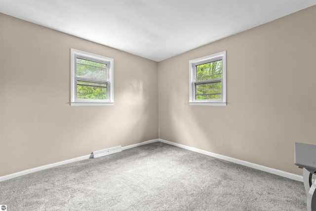 6148 S 27th Rd, Cadillac, MI 49601 - carpeted empty room featuring baseboards and a baseboard radiator