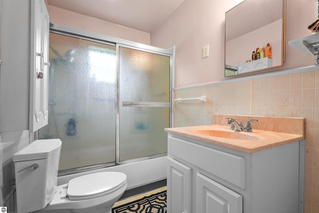 6148 S 27th Rd, Cadillac, MI 49601 - bathroom with tile walls, toilet, vanity, and shower / bath combination with glass door