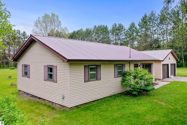6148 S 27th Rd, Cadillac, MI 49601 - view of home's exterior featuring a lawn and metal roof