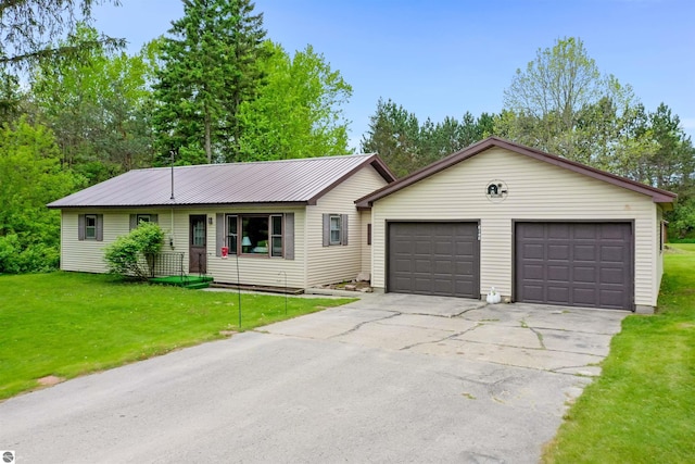 6148 S 27th Rd, Cadillac, MI 49601 - single story home with a front lawn, a detached garage, metal roof, and an outbuilding