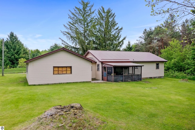 6148 S 27th Rd, Cadillac, MI 49601 - back of house with a yard, metal roof, and a sunroom