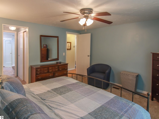 8086 Narrow Gauge Rd, Beulah, MI 49617 - bedroom with carpet floors, baseboards, a ceiling fan, and ensuite bathroom