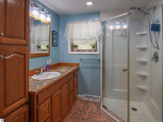 8086 Narrow Gauge Rd, Beulah, MI 49617 - full bath featuring a shower stall, vanity, and tile patterned floors