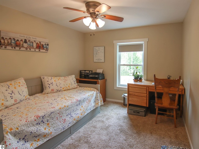 8086 Narrow Gauge Rd, Beulah, MI 49617 - bedroom with an office area, carpet flooring, baseboards, and a ceiling fan