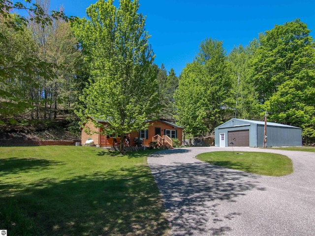 8086 Narrow Gauge Rd, Beulah, MI 49617 - view of front facade with a detached garage, an outdoor structure, gravel driveway, a front yard, and a porch