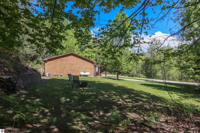 8086 Narrow Gauge Rd, Beulah, MI 49617 - view of green lawn featuring a wooded view