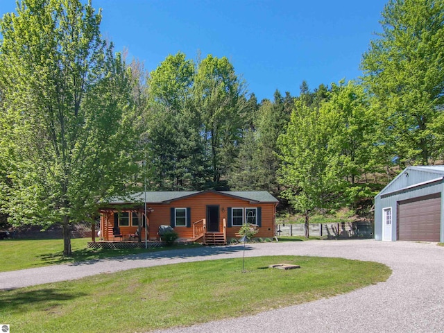 8086 Narrow Gauge Rd, Beulah, MI 49617 - view of front facade with a garage, a front lawn, covered porch, and an outdoor structure