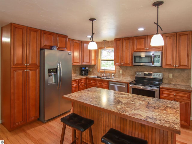 8086 Narrow Gauge Rd, Beulah, MI 49617 - kitchen with appliances with stainless steel finishes, brown cabinets, light wood-type flooring, and recessed lighting