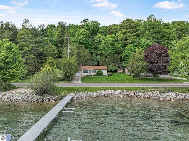7510 Crystal Dr, Beulah, MI 49616 - dock with a water view, a lawn, and a forest view