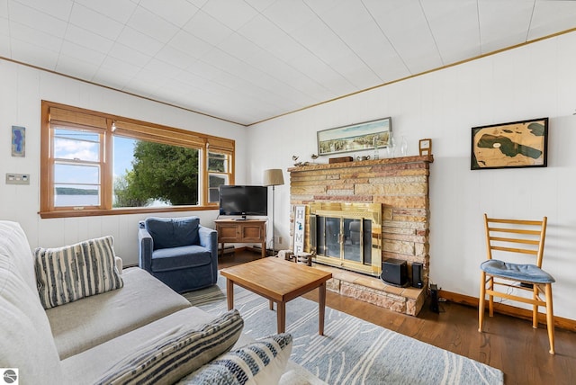 7510 Crystal Dr, Beulah, MI 49616 - living room featuring wood finished floors, a stone fireplace, and crown molding
