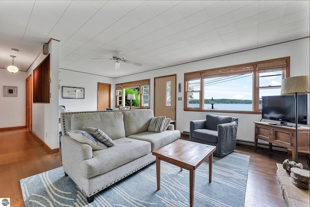 7510 Crystal Dr, Beulah, MI 49616 - living area with wood finished floors, ceiling fan, a baseboard heating unit, and baseboards