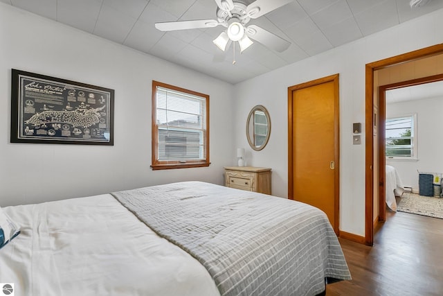 7510 Crystal Dr, Beulah, MI 49616 - bedroom with dark wood-type flooring, baseboards, and ceiling fan