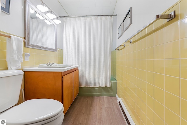 7510 Crystal Dr, Beulah, MI 49616 - full bath with tile walls, toilet, shower / tub combo with curtain, wood finished floors, and vanity