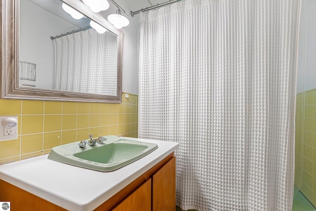 7510 Crystal Dr, Beulah, MI 49616 - full bath with tile walls, vanity, and a shower with shower curtain