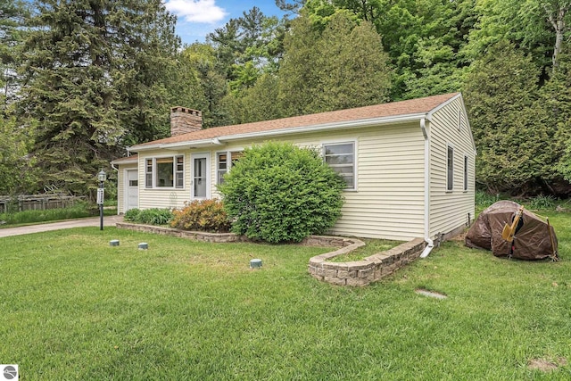 7510 Crystal Dr, Beulah, MI 49616 - view of front of house with a chimney and a front yard