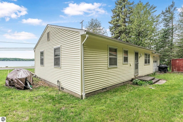 7510 Crystal Dr, Beulah, MI 49616 - view of property exterior with a lawn and a water view
