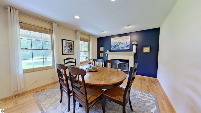 2152 Cornerstone Dr, Mount Pleasant, MI 48858 - dining area featuring a brick fireplace, light wood-style flooring, recessed lighting, and baseboards