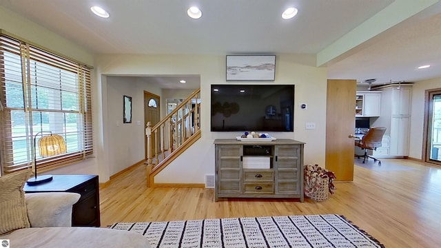 2152 Cornerstone Dr, Mount Pleasant, MI 48858 - living area with wood finished floors, stairway, a desk, baseboards, and recessed lighting