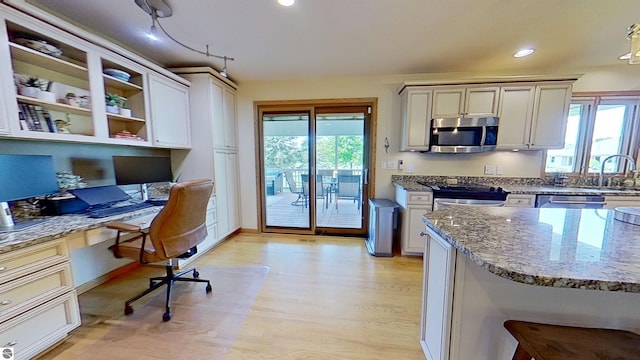 2152 Cornerstone Dr, Mount Pleasant, MI 48858 - kitchen featuring stainless steel appliances, light wood finished floors, light stone countertops, recessed lighting, and open shelves