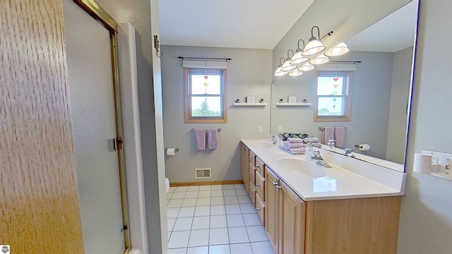 2152 Cornerstone Dr, Mount Pleasant, MI 48858 - bathroom featuring double vanity, a shower with shower door, tile patterned floors, toilet, and baseboards