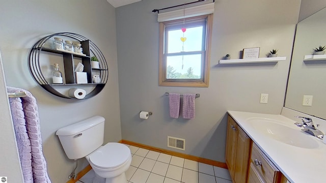 2152 Cornerstone Dr, Mount Pleasant, MI 48858 - bathroom with toilet, baseboards, tile patterned floors, and vanity