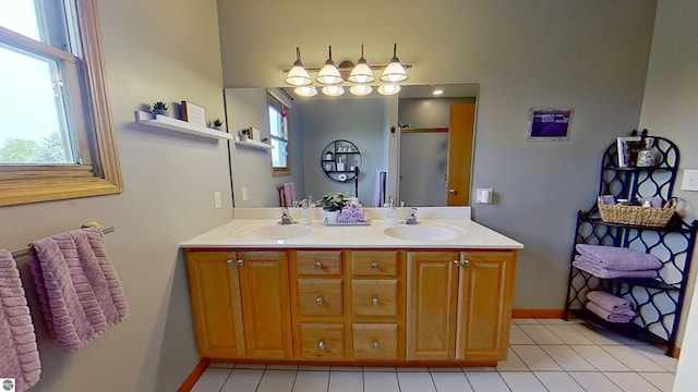 2152 Cornerstone Dr, Mount Pleasant, MI 48858 - bathroom with healthy amount of natural light, double vanity, and baseboards