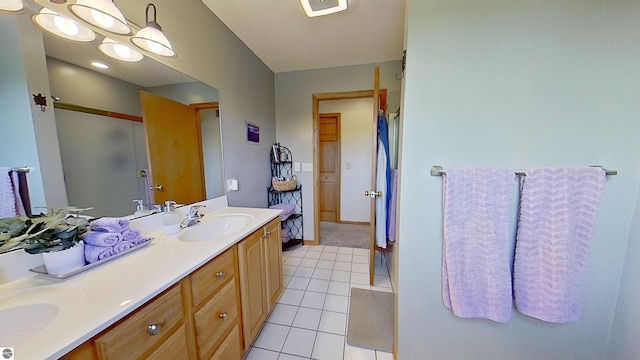 2152 Cornerstone Dr, Mount Pleasant, MI 48858 - bathroom with double vanity, tile patterned flooring, a shower with shower door, and baseboards