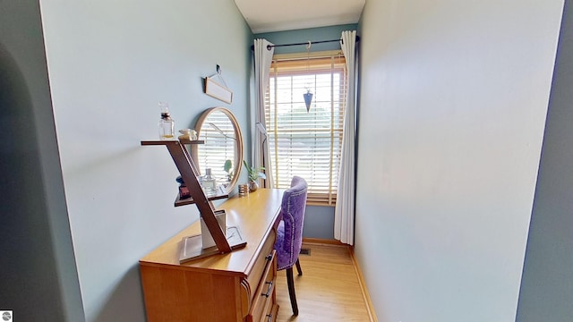 2152 Cornerstone Dr, Mount Pleasant, MI 48858 - corridor featuring light wood-style flooring, a desk, and baseboards