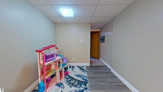 2152 Cornerstone Dr, Mount Pleasant, MI 48858 - rec room featuring a paneled ceiling, wood finished floors, and baseboards