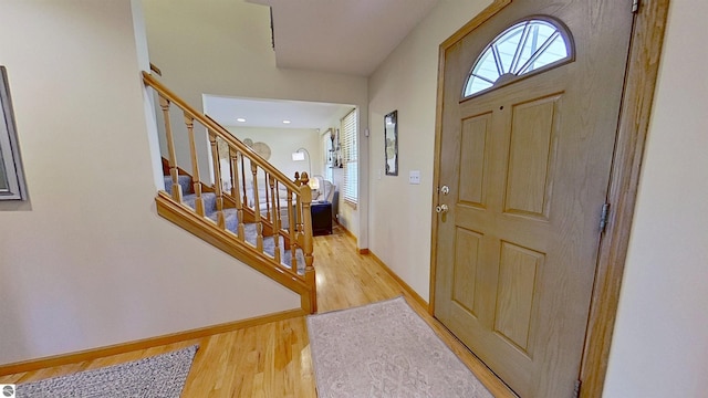 2152 Cornerstone Dr, Mount Pleasant, MI 48858 - foyer featuring wood finished floors, stairway, and baseboards