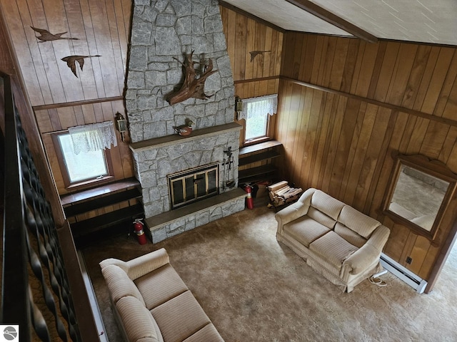 4451 Bissonette Rd, Oscoda, MI 48750 - living area with wooden walls, a baseboard heating unit, carpet floors, and a stone fireplace