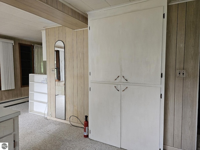 4451 Bissonette Rd, Oscoda, MI 48750 - interior space with wood walls, baseboard heating, and carpet flooring
