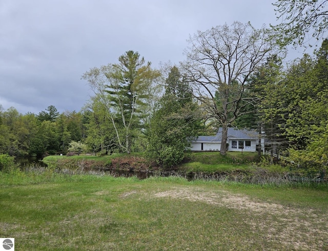 4451 Bissonette Rd, Oscoda, MI 48750 - view of yard featuring a wooded view